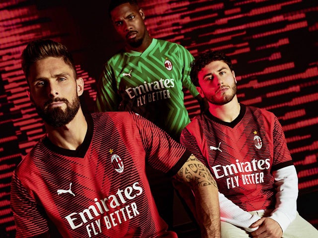 Olivier Giroud models the AC Milan 2023-24 home kit