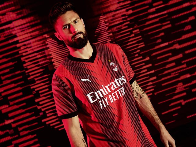 Olivier Giroud models the AC Milan 2023-24 home kit