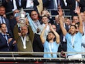 Manchester City manager Pep Guardiola celebrates with the trophy after winning the FA Cup on June 3, 2023