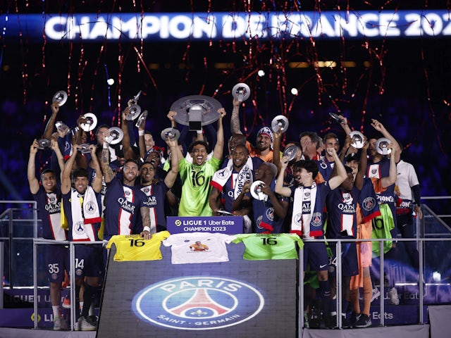 Paris Saint-Germain (PSG) players celebrate winning the Ligue 1 with the trophy on June 3, 2023