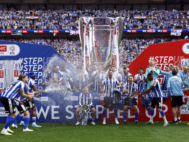 Sheffield Wednesday's Barry Bannan and teammates celebrate with the trophy on May 29, 2023