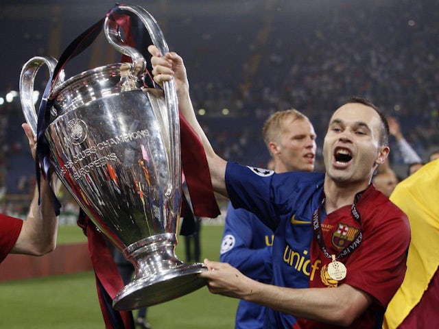 Barcelona's Andres Iniesta celebrates with the Champions League trophy in 2009