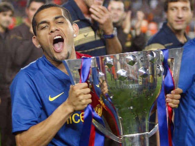 Barcelona's Dani Alves celebrates with their Spanish first division soccer league trophy at Camp Nou stadium in Barcelona May 23, 2009