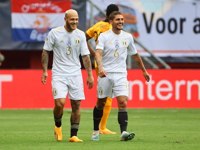 Italy's Federico Dimarco celebrates scoring their first goal with Marco Verratti on June 18, 2023