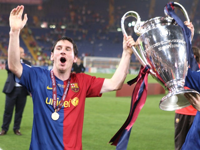 Barcelona's Lionel Messi celebrates victory with the trophy in 2009