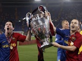 Barcelona's Lionel Messi and Andres Iniesta celebrate victory with the trophy in 2009