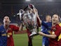 Barcelona's Lionel Messi and Andres Iniesta celebrate victory with the trophy in 2009
