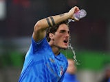 Italy's Nicolo Zaniolo gets a drink during the warm up before the match in November 2022