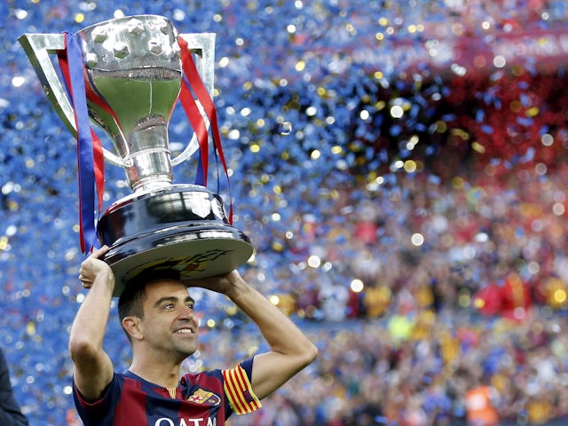 Barcelona's Xavi Hernandez raises the "La Liga " trophy in May 2015