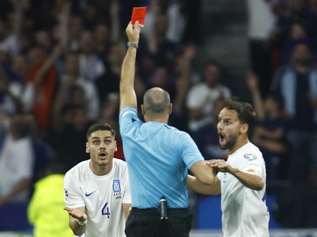 Greece's Dinos Mavropanos is shown a red card by referee Antonio Mateu Lahoz on June 19, 2023