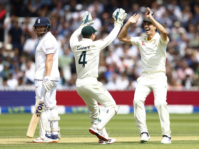 Australia's Alex Carey celebrates with Pat Cummins after running out England's Jonny Bairstow on July 2, 2023