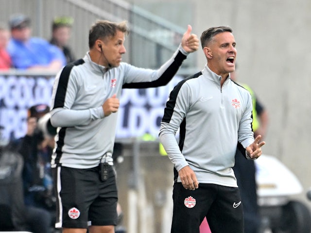 Canada head coach John Herdman (right) and assistant coach Phil Neville deliver instructions on June 29, 2023