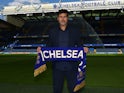 Chelsea's new manager Mauricio Pochettino poses with a scarf in the pitch after the press conference on July 7, 2023