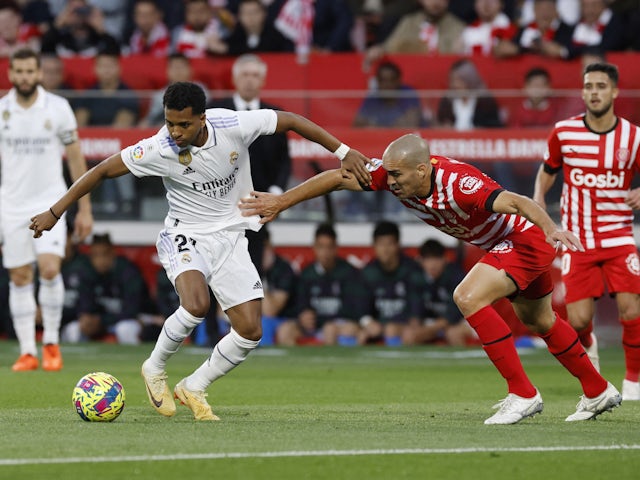 Real Madrid's Rodrygo in action with Girona's Oriol Romeu on April 25, 2023