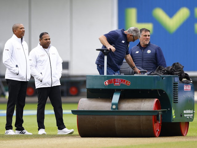 Umpires Joel Wilson and Nitin Menon with ground staff during a pitch inspection ahead of the rain delayed start of day 5 on July 23, 2023