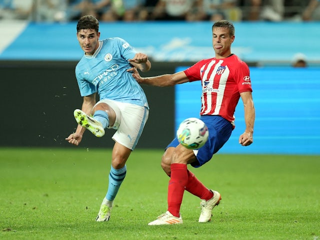 Manchester City's Julian Alvarez in action with Atletico Madrid's Cesar Azpilicueta on July 30, 2023