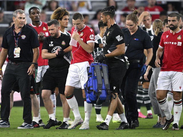 Wrexham forward Paul Mullin (10) is helped off the field after an injury on July 26, 2023