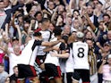 Fulham's Bobby Decordova-Reid celebrates scoring their first goal with teammates on August 12, 2023