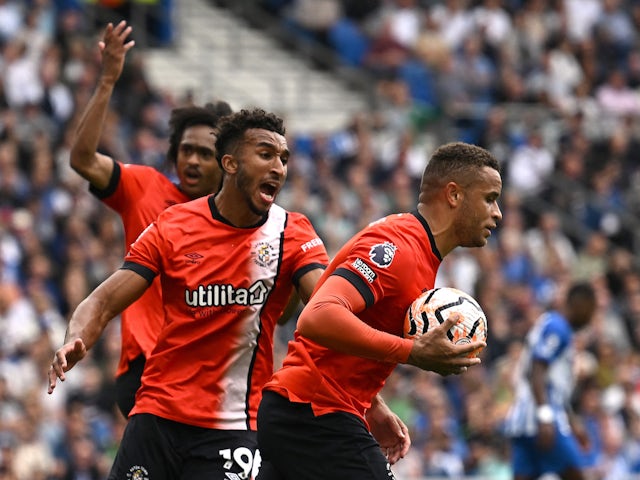 Luton Town's Carlton Morris celebrates scoring their first goal with Jacob Brown and Tahith Chong on August 12, 2023