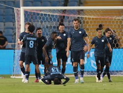 Al-Akhdoud's Andrei Burca celebrates scoring their first goal with teammates on August 14, 2023