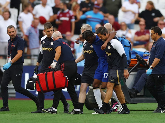 Chelsea's Carney Chukwuemeka leaves the pitch after receiving medical attention on August 20, 2023