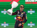 Red Bull's Max Verstappen celebrates with a trophy on the on the podium after winning the Dutch Grand Prix on August 27, 2023