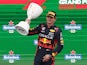 Red Bull's Max Verstappen celebrates with a trophy on the on the podium after winning the Dutch Grand Prix on August 27, 2023