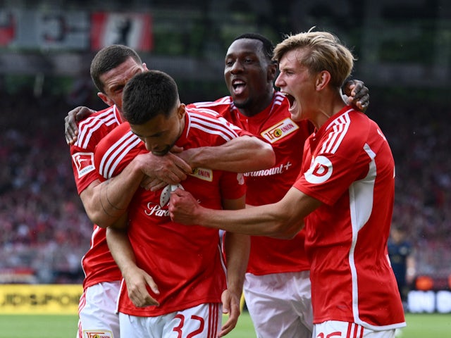 FC Union Berlin's Milos Pantovic celebrates scoring their fourth goal with Robin Gosens, Sheraldo Becker and Aljoscha Kemlein on August 20, 2023