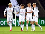 Swansea's Jamie Paterson celebrates scoring their second goal with Azeem Abdulai, Harry Darling and Jay Fulton on August 29, 2023