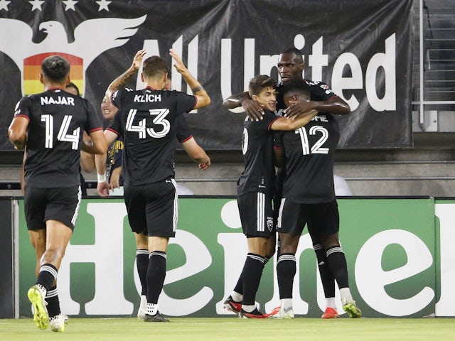 DC United forward Christian Benteke (20) celebrates with teammates after scoring a goal on September 3, 2023