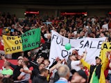 Manchester United fans display banners in protest against the Glazer family's ownership of the club on August 26, 2023