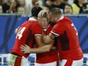 Wales' Louis Rees-Zammit celebrates scoring their third try with teammates Jac Morgan and Tomas Francis on September 9, 2023