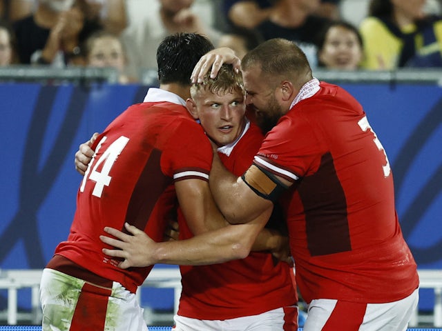 Wales' Louis Rees-Zammit celebrates scoring their third try with teammates Jac Morgan and Tomas Francis on September 9, 2023