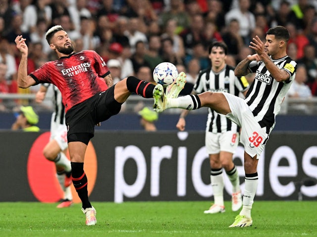 AC Milan's Olivier Giroud in action with Newcastle United's Bruno Guimaraes on September 19, 2023