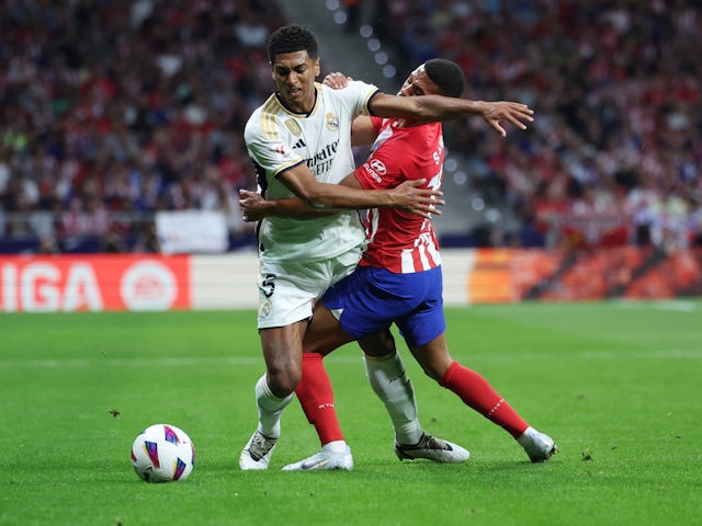 Real Madrid's Jude Bellingham in action with Atletico Madrid's Samuel Lino on September 24, 2023