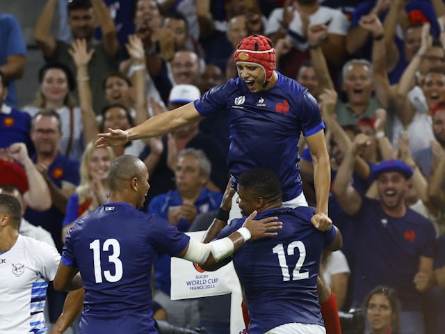 France's Jonathan Danty celebrates scoring their second try with Louis Bielle-Biarrey and Gael Fickou on September 21, 2023