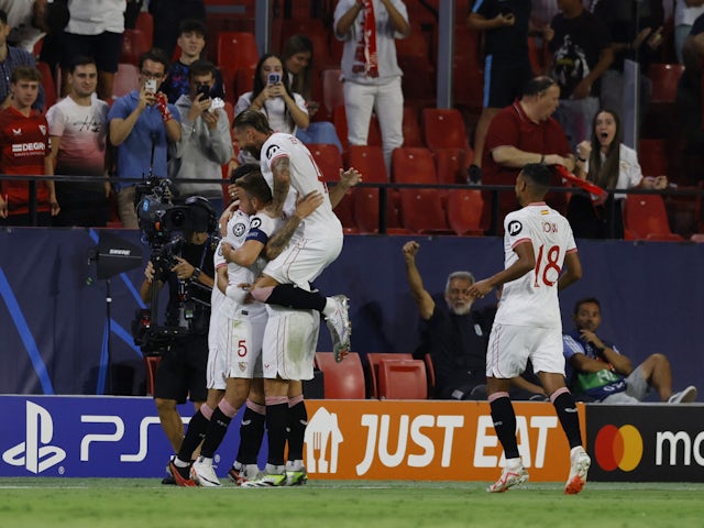 Sevilla's Lucas Ocampos celebrates scoring their first goal with teammates on September 20, 2023