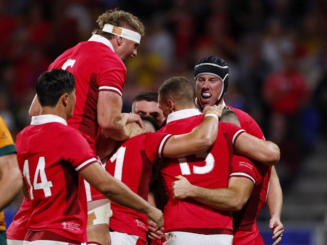Wales' Gareth Davies celebrates scoring their first try with teammates on September 24, 2023