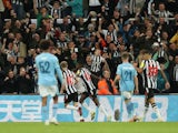 Newcastle United's Alexander Isak celebrates scoring their first goal with Anthony Gordon on September 27, 2023