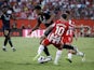 Real Madrid's Jude Bellingham in action with Almeria's Adri Embarba on August 19, 2023