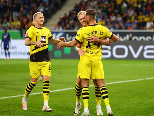 Borussia Dortmund's Niclas Fullkrug celebrates scoring their first goal with Julian Brandt and Marco Reus on September 29, 2023
