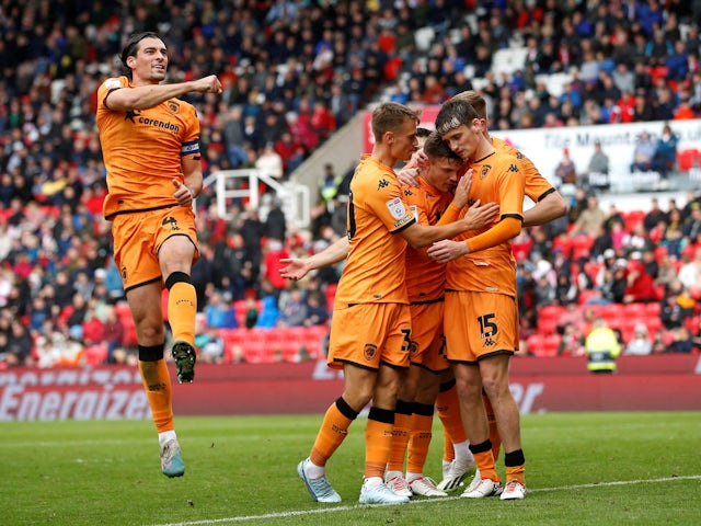 Hull City's Regan Slater celebrates with teammates after scoring their third goal on September 24, 2023