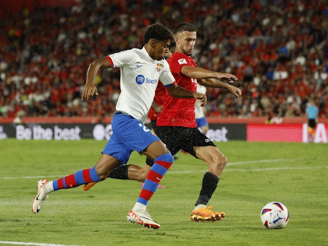 Barcelona's Lamine Yamal in action with Mallorca's Jose Manuel Copete on September 27, 2023
