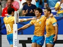 Uruguay's Nicolas Freitas celebrates scoring their second try with teammates Santiago Arata and Felipe Etcheverry on September 20, 2023