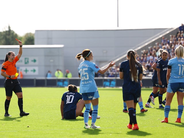 Manchester City Women's Lauren Hemp is shown a second yellow card by referee Emily Heaslip leading to a red card on October 8, 2023