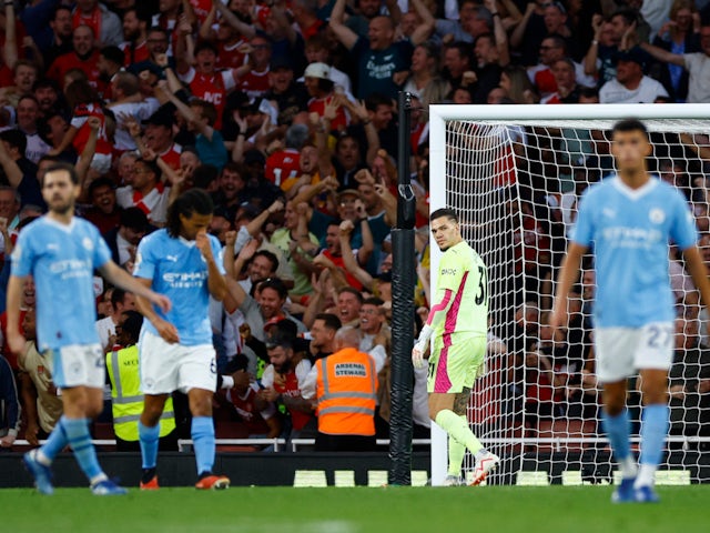 Manchester City's Ederson looks dejected after Arsenal's Gabriel Martinelli scores their first goal on October 8, 2023