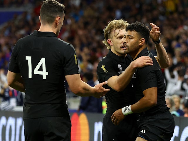 New Zealand's Richie Mo'unga celebrates scoring their second try with teammates Damian McKenzie and Will Jordan on October 5, 2023