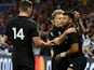New Zealand's Richie Mo'unga celebrates scoring their second try with teammates Damian McKenzie and Will Jordan on October 5, 2023