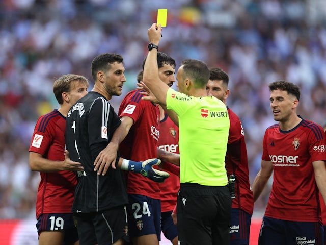 Osasuna's Kike Barja is shown a yellow card on October 7, 2023