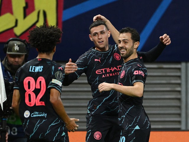 Manchester City's Phil Foden celebrates scoring their first goal with Bernardo Silva and Rico Lewis on October 4, 2023